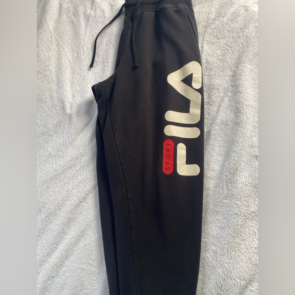 Black Fila sweatpants, tightens around ankles
